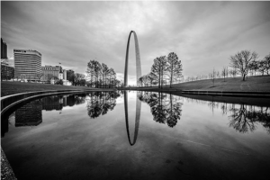 Arch reflection in pond. Black and white photo.