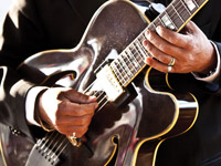 Man playing a guitar Blues Cruise Graphic