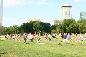 Visitors doing Yoga under the Gateway Arch