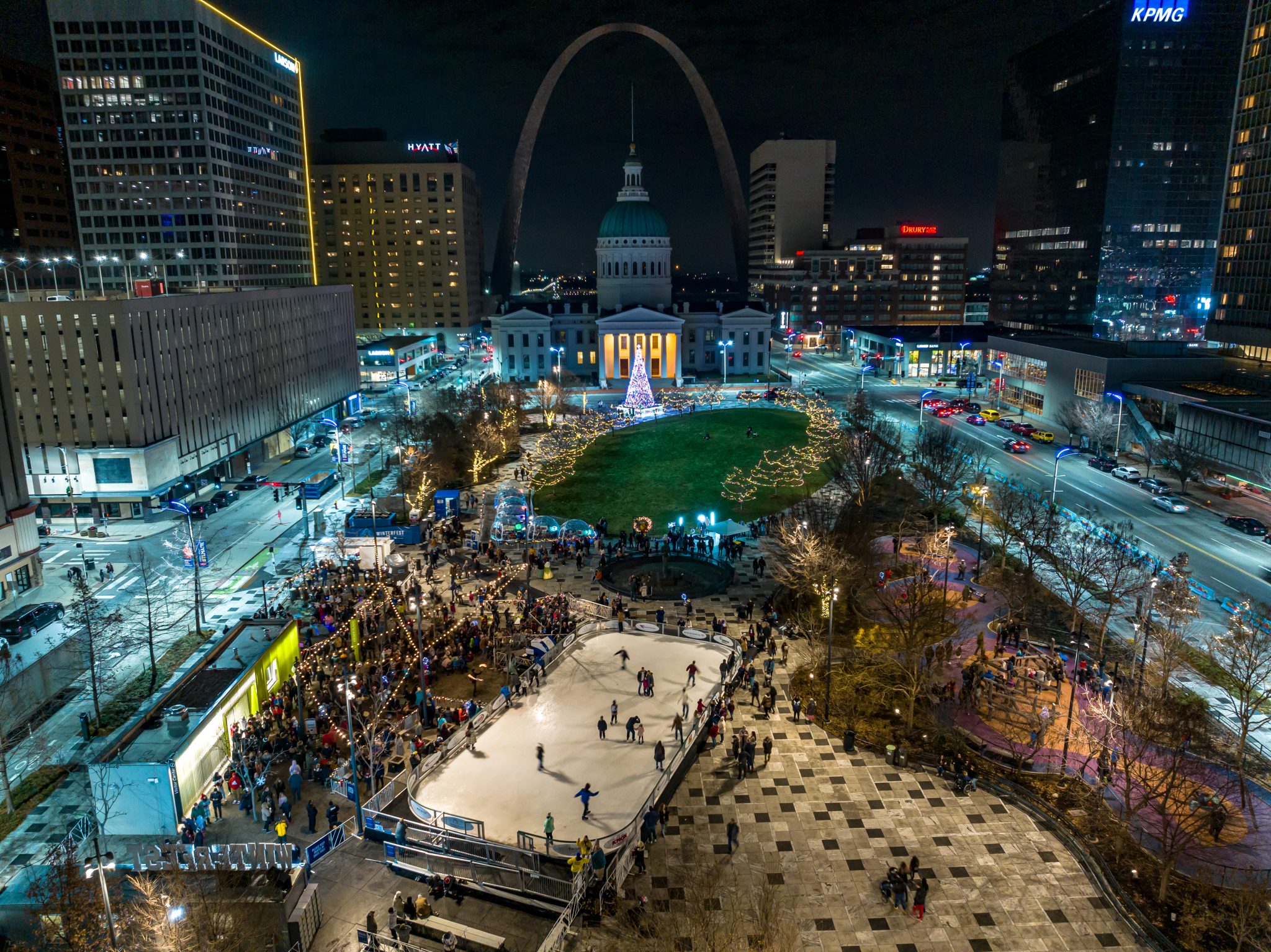 Aerial image of Kiener Plaza decorated for Winterfest at night. Provided by Gateway Arch Park Foundation.